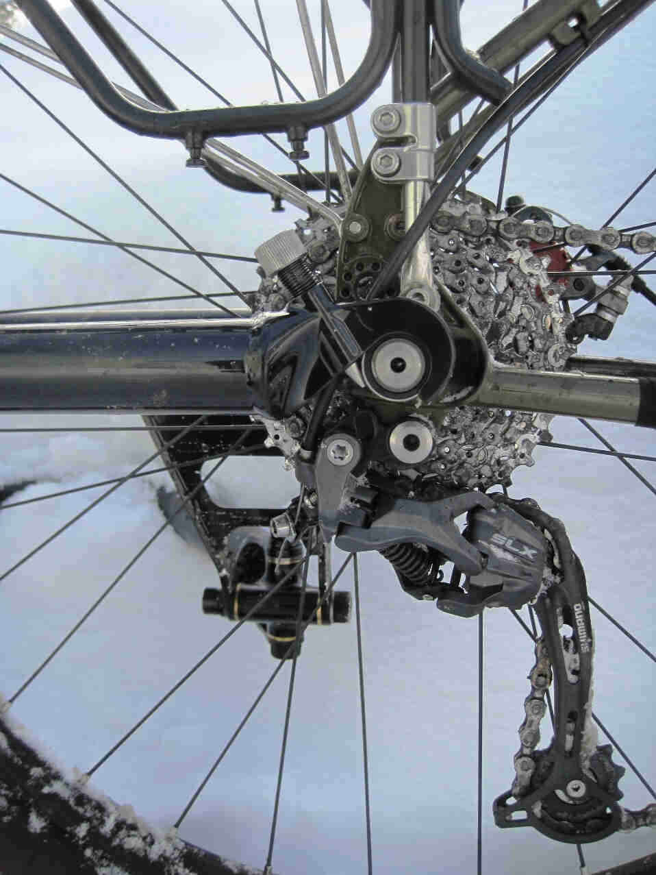 Right side, close up view of a drive side dropout from a Surly Troll bike, with snow in the background